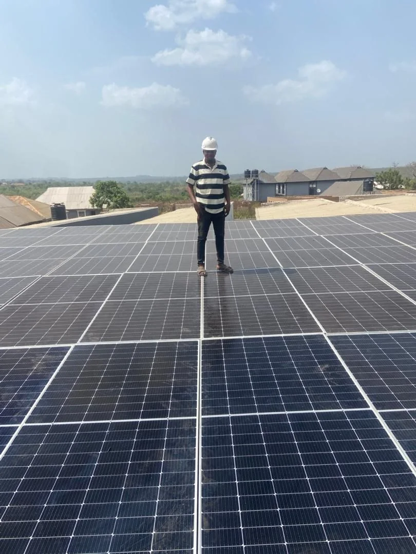 Technician inspecting a large solar array